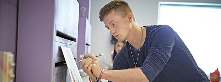 A VPA student practices airbrushing in a design lab